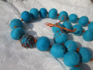 Necklace of felt balls with embroidery added